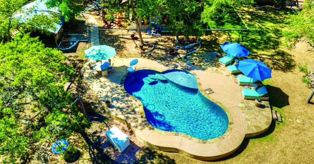 Gourmet kitchen interior illustrating the essence of modern luxury retreats with high-end appliances and a large island.