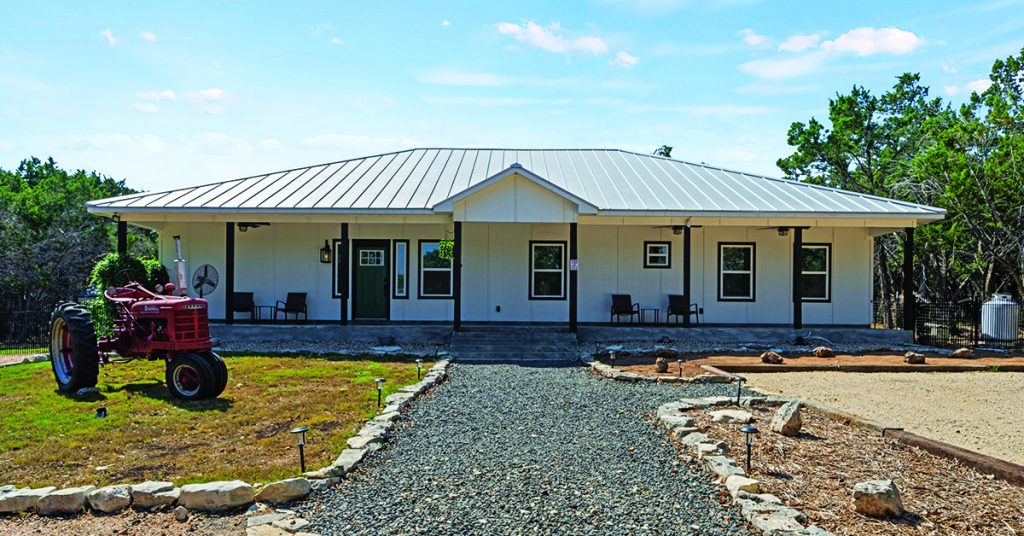 Exterior of a Wimberley vacation rental showcasing the essence of modern luxury design with clean lines and natural stone.