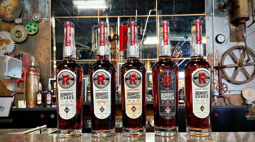 Ironroot Republic whiskey bottles on display in Wimberley, one of the best places to travel in May.