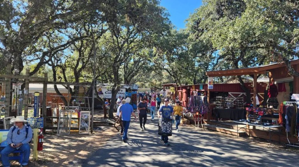 Outdoor market under shady trees in Wimberley, one of the best places to travel in May.
