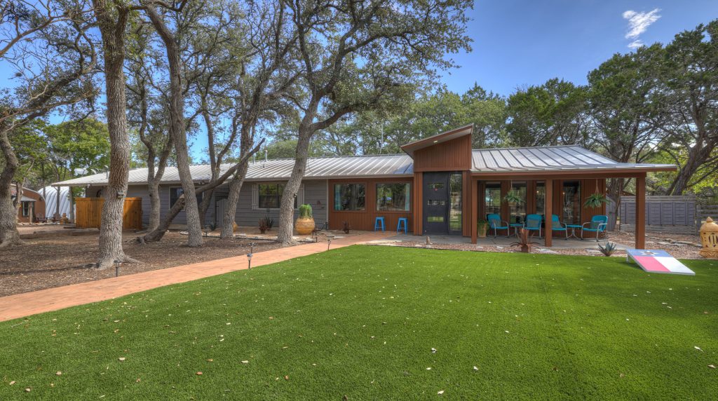 Modern vacation home near Cypress Falls Swimming Hole with patio seating.